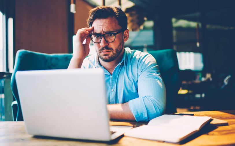 Frustrated business owner in front of a laptop